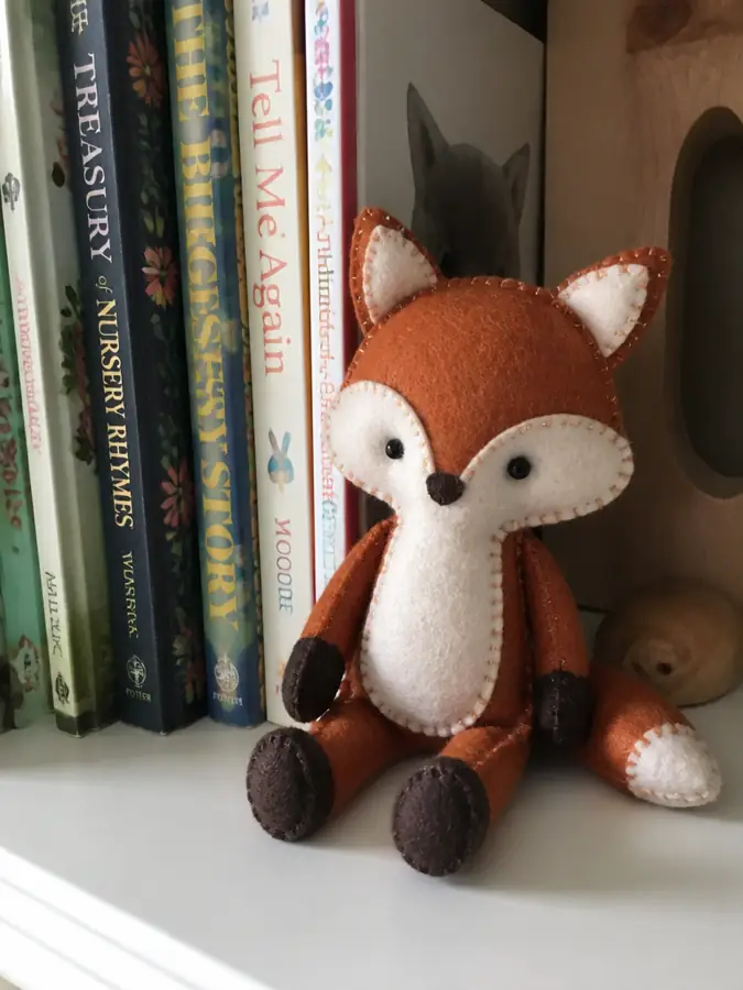 Felt fox on a bookshelf
